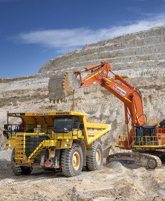 Excavator loading debris into a mining dump truck